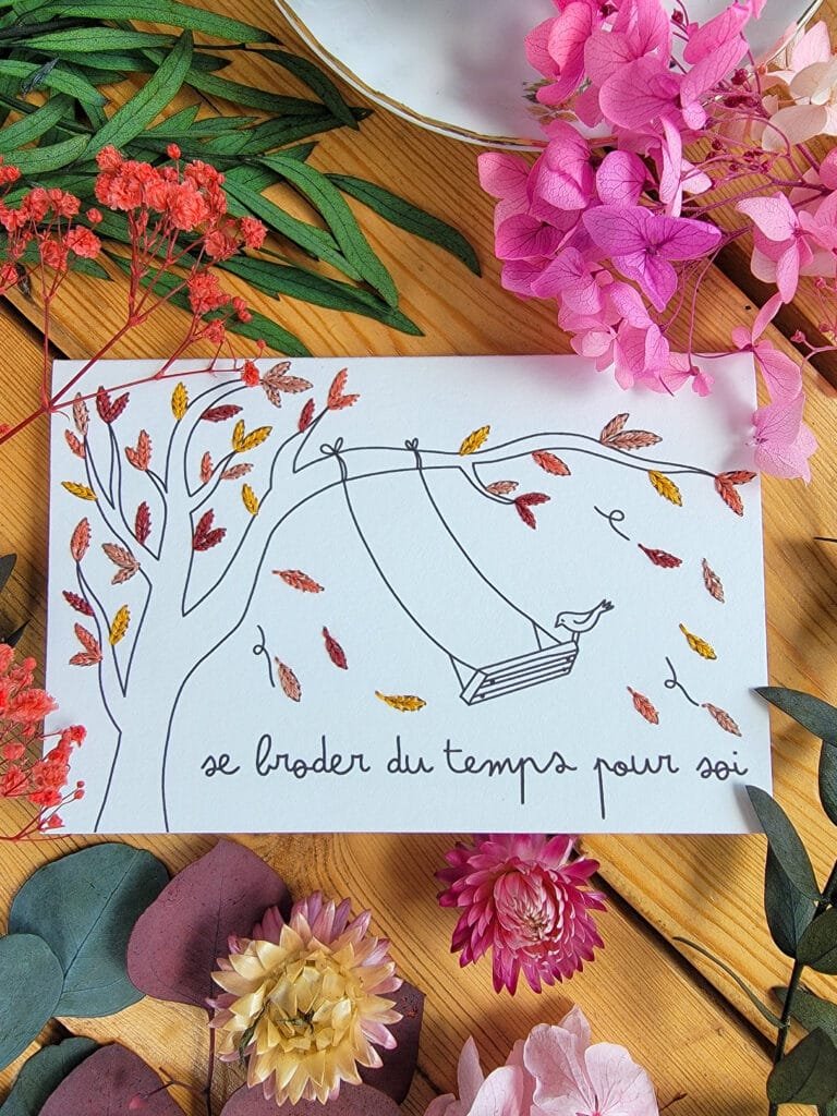 Carte à broder : balançoire suspendue dans un arbre avec petit oiseau